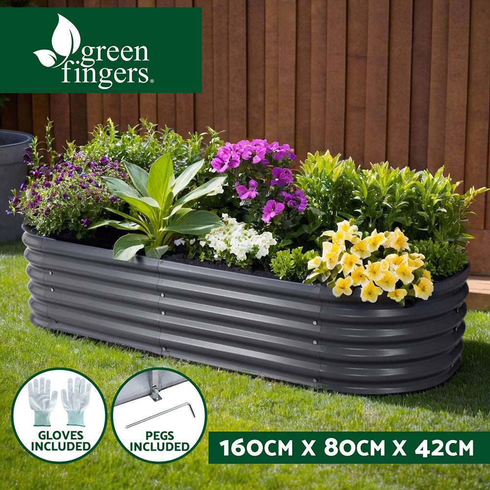 Raised garden bed with flowers and plants in backyard