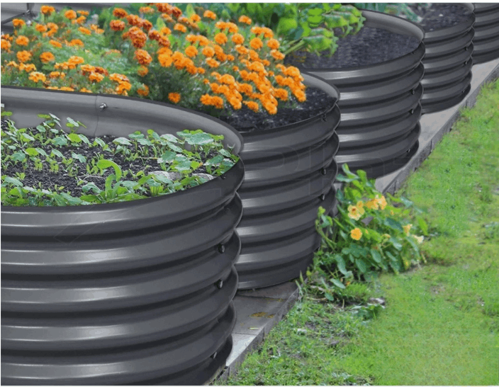 Round raised garden bed filled with soil and flowers