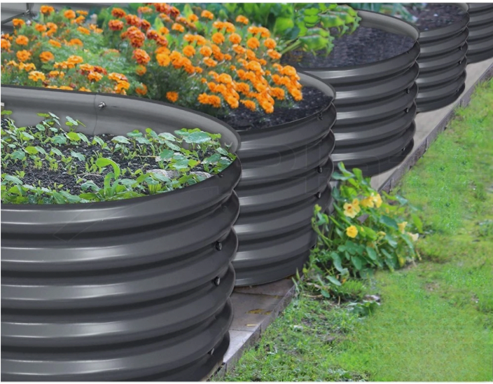 Round raised garden bed filled with soil and flowers
